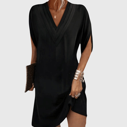 Black dress worn by a person on a white background
