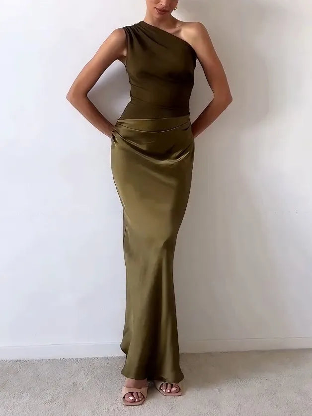 Woman wearing an olive green one-shoulder dress against a white background