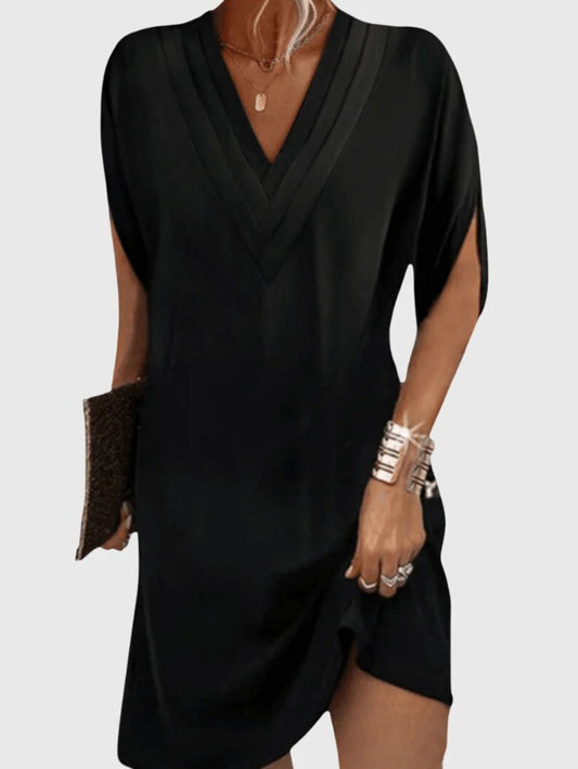 Black dress worn by a person on a white background