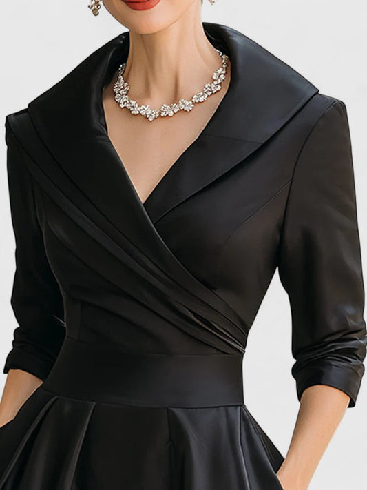 Black dress with a collar and long sleeves on a white background